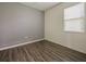Bedroom with grey walls, laminate flooring and window at 2829 Shelburne Way, St Cloud, FL 34772