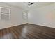 Spacious bedroom with windows and wood-look flooring, offering a bright and modern aesthetic at 2829 Shelburne Way, St Cloud, FL 34772