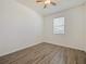 Bedroom with a window and wood-look flooring, offering a bright and modern look at 2829 Shelburne Way, St Cloud, FL 34772