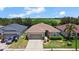 Charming single Gathering home featuring a two-car garage and well manicured lawn with trees in the background at 2829 Shelburne Way, St Cloud, FL 34772
