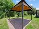 An outdoor gazebo with brick flooring, offering shade and an entertainment area in the yard at 2829 Shelburne Way, St Cloud, FL 34772