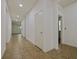 Hallway with tile flooring and a series of doors leading into other rooms at 2829 Shelburne Way, St Cloud, FL 34772