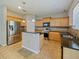 Well-lit kitchen featuring stainless steel appliances, granite counters, and light wood cabinets at 2829 Shelburne Way, St Cloud, FL 34772