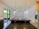Kitchen island with view into a spacious living area and sliding door that leads to outside patio at 2829 Shelburne Way, St Cloud, FL 34772