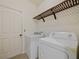 A laundry room equipped with washer and dryer hookups, plus a wooden rack for storage at 2829 Shelburne Way, St Cloud, FL 34772