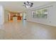 Open-concept living room that flows into a kitchen with natural light from a large window at 2829 Shelburne Way, St Cloud, FL 34772