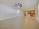 Open concept living room with tile floors and ceiling fan leading into the eat-in kitchen at 2829 Shelburne Way, St Cloud, FL 34772
