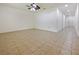 Spacious living room with tile flooring, neutral walls, and a ceiling fan at 2829 Shelburne Way, St Cloud, FL 34772
