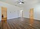 Main bedroom showcasing wood-look flooring and multiple doorways to the en-suite at 2829 Shelburne Way, St Cloud, FL 34772