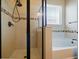Modern bathroom features a glass-enclosed shower and soaking tub, with tiled accents at 2829 Shelburne Way, St Cloud, FL 34772