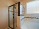 Modern bathroom features a glass-enclosed shower and soaking tub, plus tiled accents at 2829 Shelburne Way, St Cloud, FL 34772