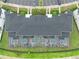 Overhead view of townhomes with screened-in pools, gardens, and parking at 4403 Scene Ln, Kissimmee, FL 34746