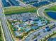 Aerial view of neighborhood amenities, pool, lazy river, play ground, and surrounding homes at 4403 Scene Ln, Kissimmee, FL 34746