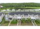 Scenic aerial view of townhomes backing to a tranquil pond surrounded by lush greenery at 4403 Scene Ln, Kissimmee, FL 34746