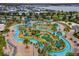 Aerial view highlighting the expansive lazy river and the manicured mini-golf course at 4403 Scene Ln, Kissimmee, FL 34746