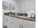 Bathroom with a double vanity with framed mirrors and vanity countertop decor at 4403 Scene Ln, Kissimmee, FL 34746