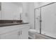 Clean bathroom featuring a modern vanity, toilet, and a glass-enclosed shower at 4403 Scene Ln, Kissimmee, FL 34746
