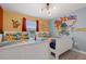 Themed bedroom featuring cartoon decor, twin beds, and vibrant colors and designs at 4403 Scene Ln, Kissimmee, FL 34746