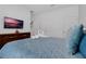 Comfortable bedroom with a bed, dresser, and TV, offering a relaxing space at 4403 Scene Ln, Kissimmee, FL 34746