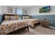 Bright bedroom furnished with two twin beds featuring floral patterned bedding and ample natural light at 4403 Scene Ln, Kissimmee, FL 34746