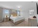 Serene bedroom with a king bed, matching nightstands, and a peek into the bathroom at 4403 Scene Ln, Kissimmee, FL 34746