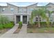 Inviting townhome facade boasting well-maintained landscaping, a welcoming entrance, and contemporary architectural details at 4403 Scene Ln, Kissimmee, FL 34746