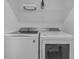 Modern laundry room featuring front-load washer and dryer, and storage space at 4403 Scene Ln, Kissimmee, FL 34746