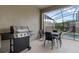 Outdoor patio with a grill, dining table, and a view of the screened-in pool at 4403 Scene Ln, Kissimmee, FL 34746