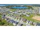 Expansive aerial view of a well-maintained residential community featuring a central lake and a community pool at 454 Sunfish Dr, Winter Haven, FL 33881