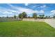 Large fenced backyard, featuring a well-maintained lawn and some young trees at 454 Sunfish Dr, Winter Haven, FL 33881