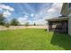 Large, fenced backyard featuring a screened-in lanai and well-maintained lawn, ideal for outdoor enjoyment at 454 Sunfish Dr, Winter Haven, FL 33881