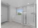 Relaxing primary bathroom with a soaking tub, tiled shower, and a bright window at 454 Sunfish Dr, Winter Haven, FL 33881