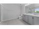 This bath offers double sinks, tile floors, and a step-in shower at 454 Sunfish Dr, Winter Haven, FL 33881