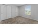 This bedroom features carpeted floors, double door closet, and a window with lovely neighborhood views at 454 Sunfish Dr, Winter Haven, FL 33881