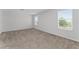 A light and bright bedroom features two large windows and carpeted flooring at 454 Sunfish Dr, Winter Haven, FL 33881