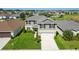 Lovely two-story home featuring a spacious yard and a community pool nearby, perfect for Gathering living at 454 Sunfish Dr, Winter Haven, FL 33881