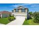 Two-story home with a two-car garage, manicured lawn, and inviting curb appeal in a friendly neighborhood at 454 Sunfish Dr, Winter Haven, FL 33881