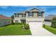 Beautiful two-story home with a well-kept lawn, two-car garage, and a classic suburban appeal at 454 Sunfish Dr, Winter Haven, FL 33881