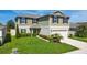 Charming two-story home with a well-manicured lawn, two-car garage, and inviting front entrance at 454 Sunfish Dr, Winter Haven, FL 33881