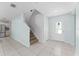 Bright foyer features neutral tile flooring, a staircase, and a front door with decorative glass at 454 Sunfish Dr, Winter Haven, FL 33881