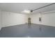 Attached two-car garage with concrete floors and white walls provides secure parking at 454 Sunfish Dr, Winter Haven, FL 33881