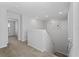 Upstairs hallway with carpeted flooring, and views into the bedroom and laundry room at 454 Sunfish Dr, Winter Haven, FL 33881