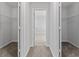 Hallway with views into two walk-in closets, and a large bedroom with tile floors at 454 Sunfish Dr, Winter Haven, FL 33881