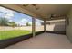 View from a screened lanai overlooking a spacious, fenced backyard with lush greenery at 454 Sunfish Dr, Winter Haven, FL 33881