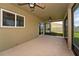 Covered and screened lanai with ceiling fans, providing a comfortable outdoor living space at 454 Sunfish Dr, Winter Haven, FL 33881
