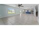 Bright living room with ample natural light, tile floors, and an open layout to the kitchen area at 454 Sunfish Dr, Winter Haven, FL 33881