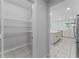 Well-organized pantry with wire shelving and access to the bright kitchen with a central island at 454 Sunfish Dr, Winter Haven, FL 33881