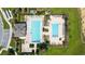 Aerial view of a community pool with ample lounge chairs, surrounded by lush landscaping at 454 Sunfish Dr, Winter Haven, FL 33881