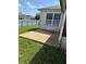 A grassy backyard with a partial view of the home at 506 Myakka Pl, Kissimmee, FL 34759