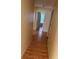Hallway with wood floors leading to rooms with neutral wall paint at 506 Myakka Pl, Kissimmee, FL 34759